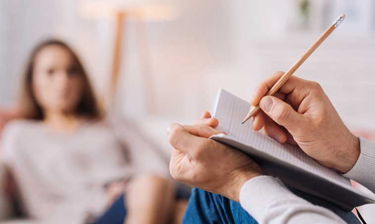 woman being seen by psychotherapist