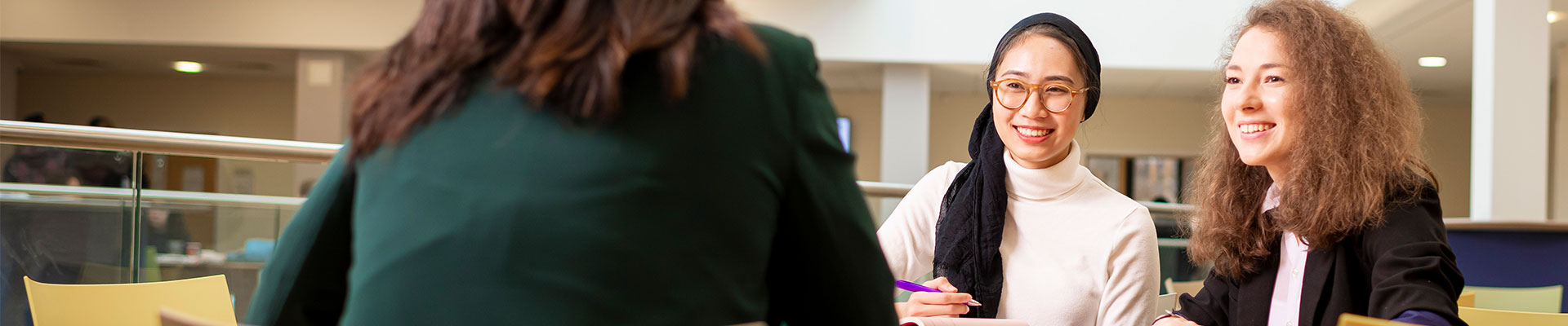 two students sitting together in a seminar space