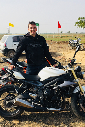 Tom Llewellyn on a motorbike travelling